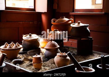 Interior Kitchen room of ancient wooden house or antique wood home in Khum Khun Phaen garden park in Wat Khae temple for thai people foreign traveler Stock Photo