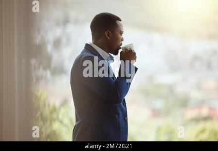 Thinking businessman, travel or drinking coffee by window in airport lounge, hotel lobby or modern office building. Corporate worker, employee or Stock Photo