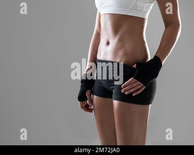 Not an ounce of fat to be found. a woman wearing kickboxing clothing. Stock Photo
