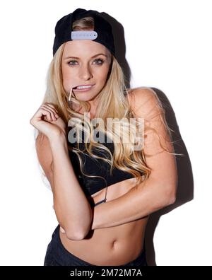 Rebel at heart. a rebellious young woman wearing a cap posing with a lollipop in her mouth. Stock Photo