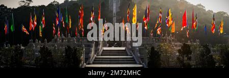 Panorama of flags around the circular stone platform at the base of the staircase leading up to the Tian Tan Buddha, Lantau Island, Hong Kong Stock Photo