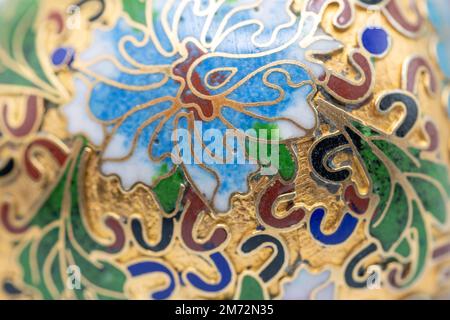 Macro abstract texture background of antique cloisonne with multicolored enamel on a gold base, showing some wear from age Stock Photo