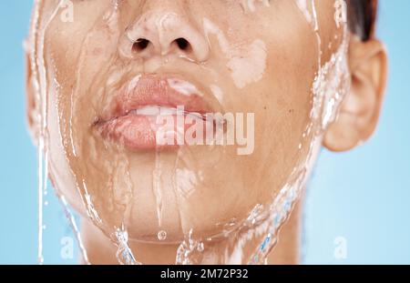 Woman, washing face or water drops skincare on blue background studio in lips healthcare wellness, hygiene cleaning or mouth moisture grooming. Zoom Stock Photo
