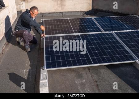 Installation of solar panels for the production of electricity on a house terrace. Abruzzo, Italy, Europe Stock Photo