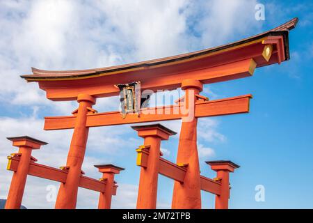 The fifty-foot tall vermilion otorii gate ('great gate') of Itsukushima Shrine, the site's most recognizable landmark.  It appears to float. Stock Photo