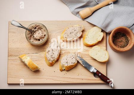 Homemade liver pate spread on baguette slices. Stock Photo