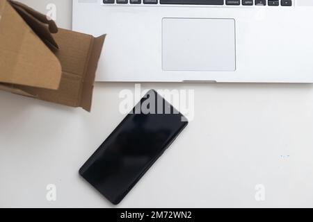 Shopping online e-comerce, Parcel boxes on a laptop. Stock Photo