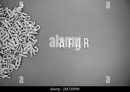 AFAR in wooden English language capital letters spilling from a pile of ...
