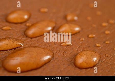 Round water drops on brown leather texture, side view, soft focus macro pattern Stock Photo