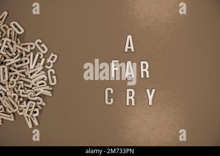 A FAR CRY in wooden English language capital letters spilling from a ...