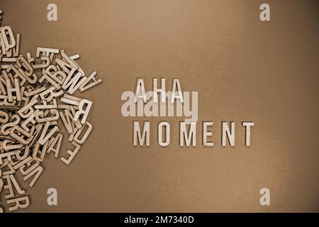 AHA MOMENT in wooden English words language capital letters spilling ...
