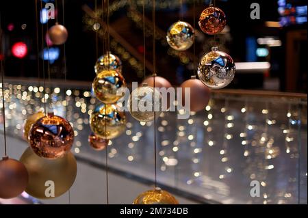 New Year's multi-colored balls hang from above. Christmas decorations. Stock Photo