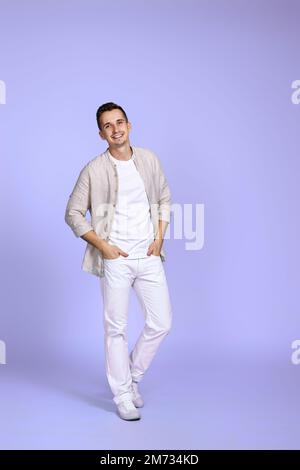 man in casual shirt posing on purple background. Stock Photo