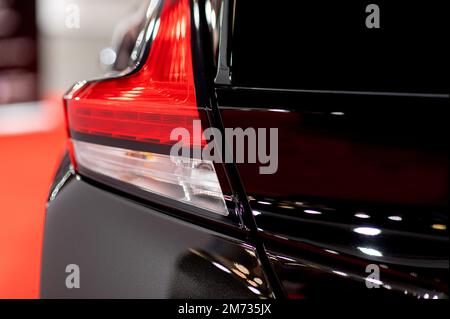Tail light of nice and new black sport suv car in modern garage. Stock Photo