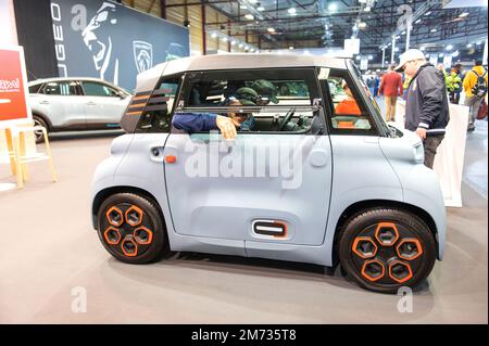 Riga,Latvia - April 29, 2022: People are enjoying about french small Citroen Ami electric two-seater micro-city car . Stock Photo