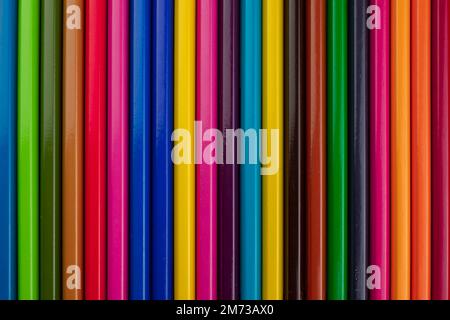 School colored pencils arranged in a row vertically in different bright colors Stock Photo