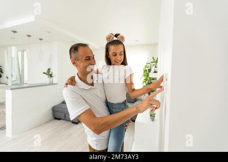 Controlling home heating temperature with a smart home, close-up on phone. Concept of a smart home and mobile application for managing smart devices Stock Photo