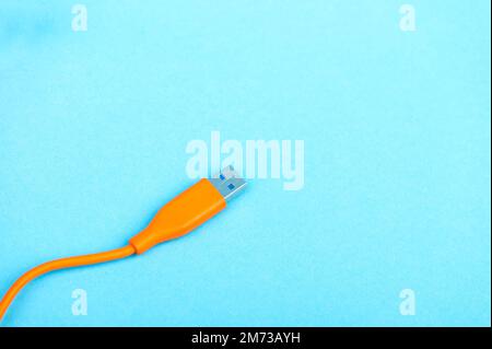USB Cable Plug isolated on Blue Background Stock Photo