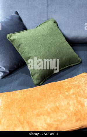 Green and brown pillows on gray couch, home decor Stock Photo