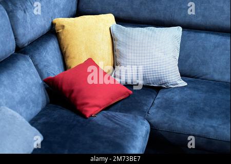Closeup view of multicolor pillows on blue couch Stock Photo