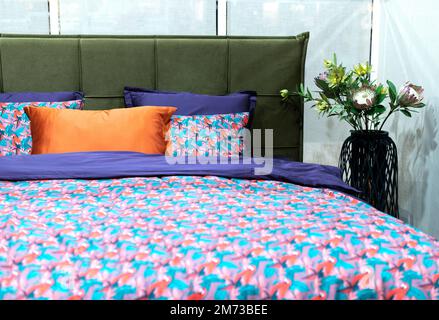 interior of modern bedroom with soft bed and multicolor pillows Stock Photo