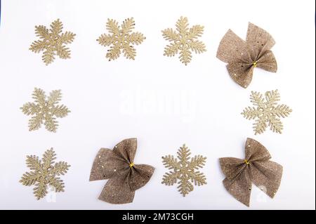 Burlap bow with gold glitter and snowflakes on white background ...