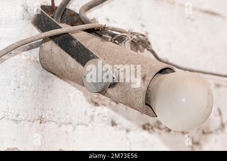 old lightbulb, vintage bulb holder, real electrical installation Stock Photo