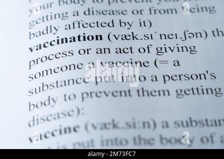 A mock up of a dictionary page with the word vaccination with selective focussing Stock Photo