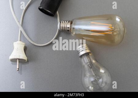 Power energy saving concept. light bulb with light on on gray background. Stock Photo