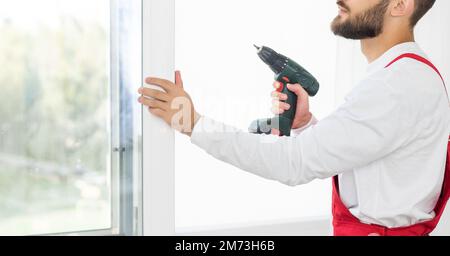 Close up of a mans hand holding screwdriver machine Stock Photo