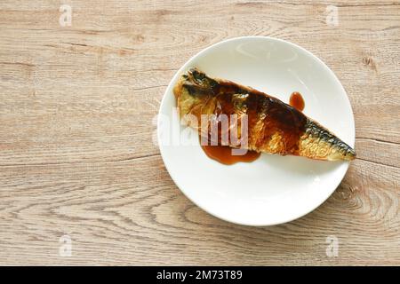 grilled saba fish or mackerel on plate dressing black sweet soybean sauce Stock Photo