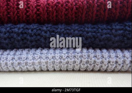 Pile of knitted cotton pullovers of different colors Stock Photo