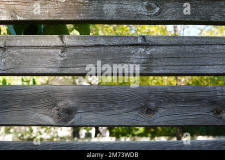Rough textured surface with cracks and knots of rustic old fence of horizontal wooden planks Stock Photo