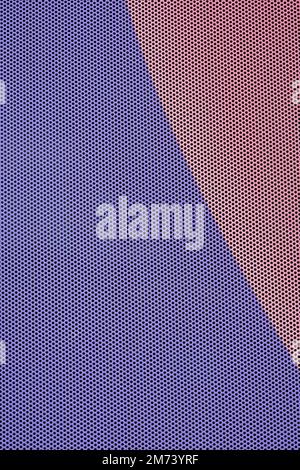 Perforated metal sheet in pink and blue colors background Stock Photo