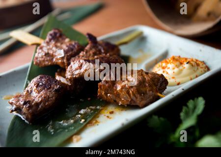 Beef skewer with some mayonnaise on the side Stock Photo