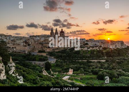 Il-Mellieha, Malta - skyline view of Mellieha town at sunset with Paris Church on hill top. Stock Photo