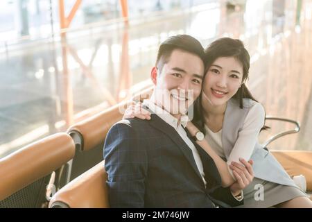 Young couples in the airport lounge Stock Photo - Alamy
