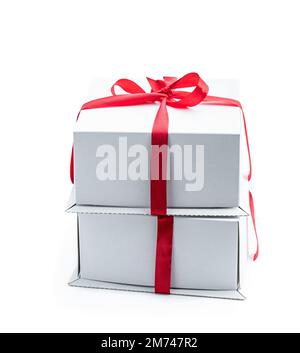Stack  of two gift boxes wrapped with red ribbon isolated on white Stock Photo