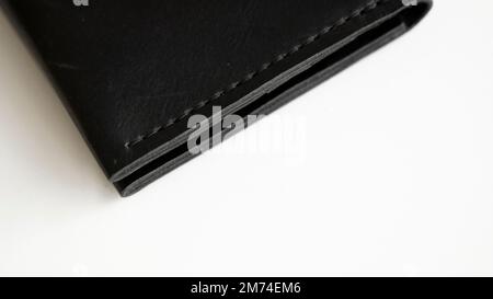 Details of open handmade brown man's genuine leather wallet with zipper on a button for banknotes and credit cards isolated on white background. Stock Photo