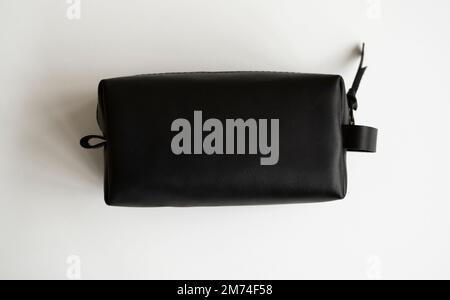 Man's black leather personal cosmetic bag or pouch for toiletry accessory. Style, retro, fashion, vintage and elegance. Stock Photo