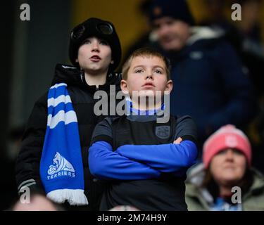 Young Huddersfield Town fans watch on during the Emirates FA Cup Third Round match Preston North End vs Huddersfield Town at Deepdale, Preston, United Kingdom, 7th January 2023  (Photo by Steve Flynn/News Images) Stock Photo