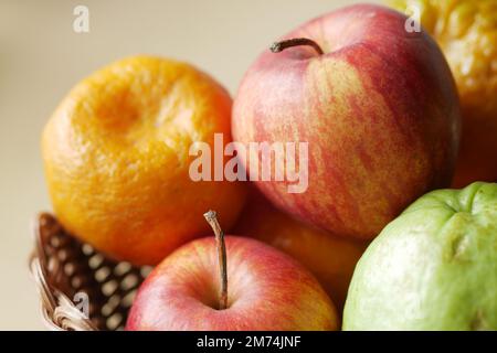 close up of apple and orange in a bowl on orange background . Stock Photo