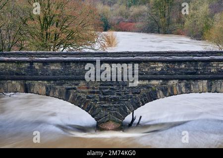 The Ynys Bridge over a full River Taff after heavy rain in South Wales Stock Photo