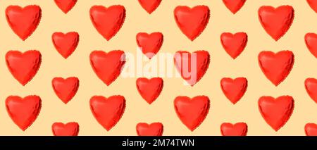 Many heart-shaped balloons on beige background. Patter for Valentine's Day Stock Photo