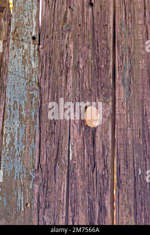 Faded light brown wood material background with small hole Stock Photo