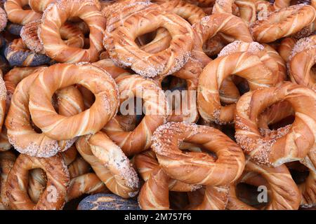 Obwarzanki (singular: obwarzanek), Cracows kinda pretzels or bagels. Ring-shaped braided bread snacks sprinkled with poppy, or sesame seeds or salt. Stock Photo