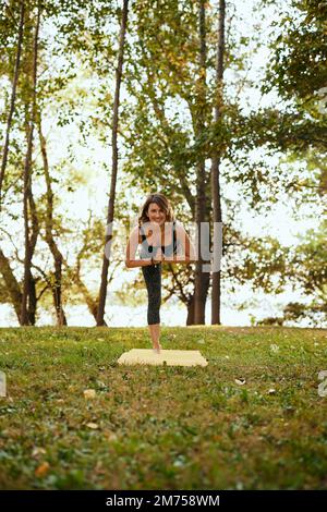Yogi Woman Balancing in Tree Pose Outdoors Stock Photo - Alamy