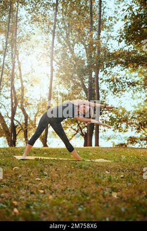 Yogi woman practicing yoga in nature in the forest. Stock Photo