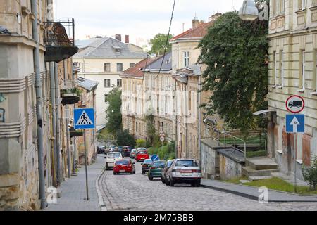 LVIV, UKRAINE - SEPTEMBER 11, 2022 Street view of the historical old city in Lviv, Ukraine. Many old buildings and facade ornaments in tight european style streets of Lviv Stock Photo