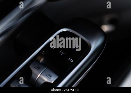 Side mirrors control panel on side door. Car driver adjust side mirror controller. Side mirror control button for adjusting the mirrors. Stock Photo